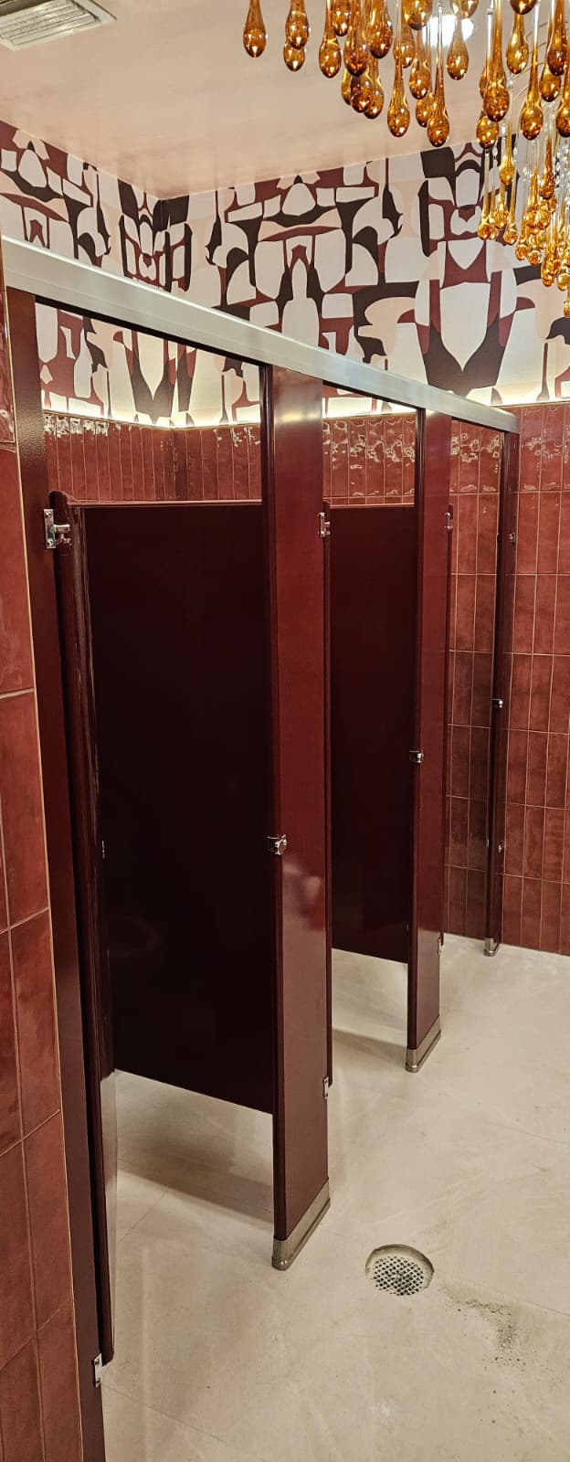Burgundy powder-coated steel restroom stalls at Casa Mezcal in Orlando, Florida