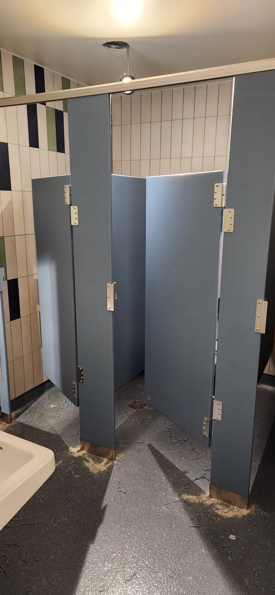Wider view of solid-plastic commercial restroom stalls at Buchanan-Verplanck Elementary School in Buchanan, New York