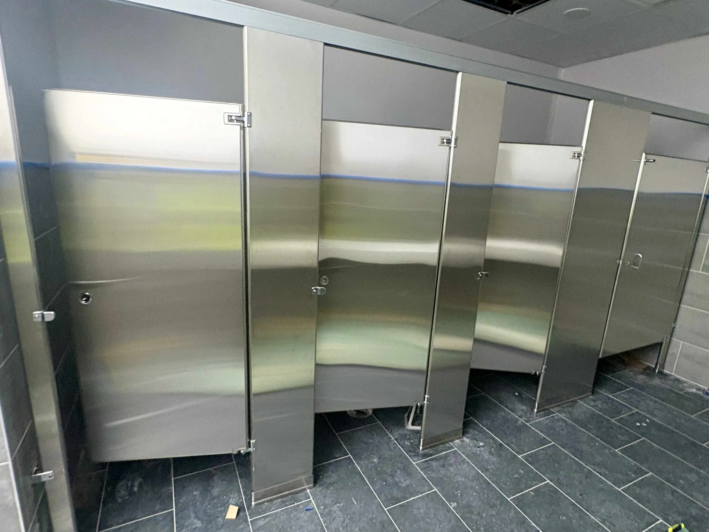 Stainless-steel commercial restroom stalls at Compal USA Technology in Georgetown, Texas