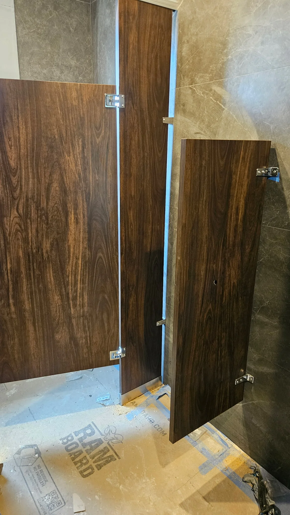 Wood-look Plastic Laminate commercial restroom stall doors and partitions at La Maison in Greenwich, Connecticut during installation