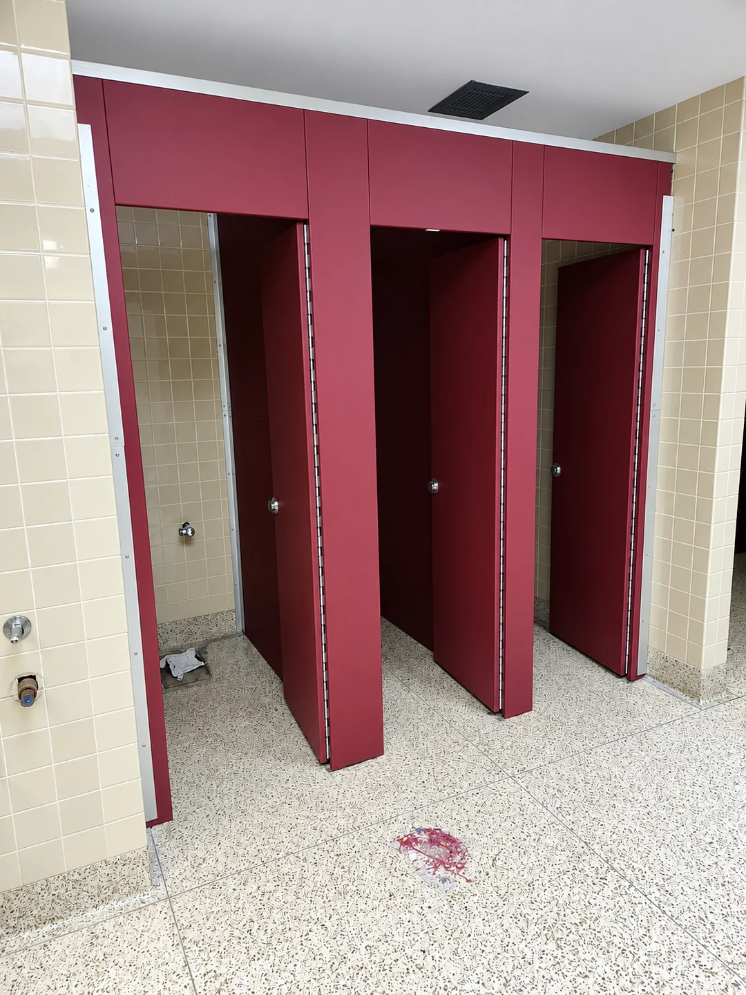 Wider view of Scranton Aria solid-plastic commercial restroom stalls at New Paltz High School in New Paltz, New York