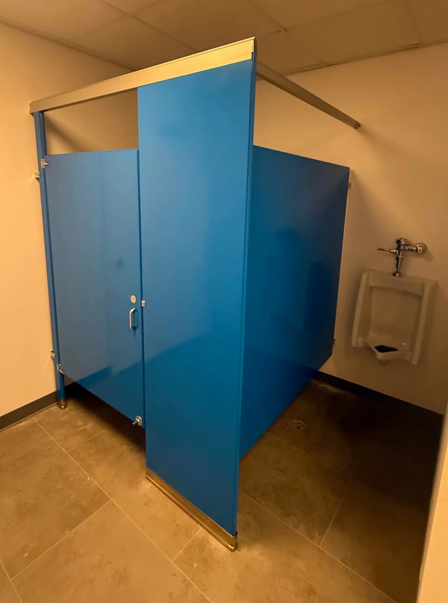 Blue powder-coated-steel commercial restroom stall at the YouthBuild Newark project in Newark, New Jersey